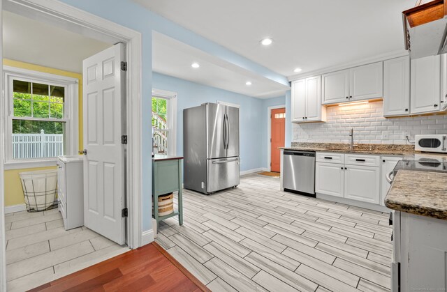 29 E Cliff St, Norwich, CT 06360 - kitchen featuring stainless steel appliances, baseboards, healthy amount of natural light, a sink, and recessed lighting