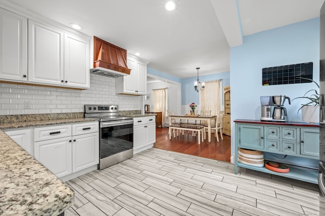 29 E Cliff St, Norwich, CT 06360 - kitchen with stainless steel electric stove, white cabinets, tasteful backsplash, and recessed lighting