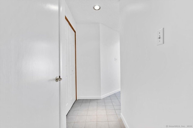 hall with baseboards and recessed lighting