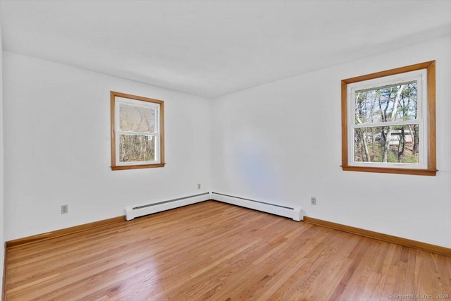 unfurnished room featuring wood finished floors and baseboards