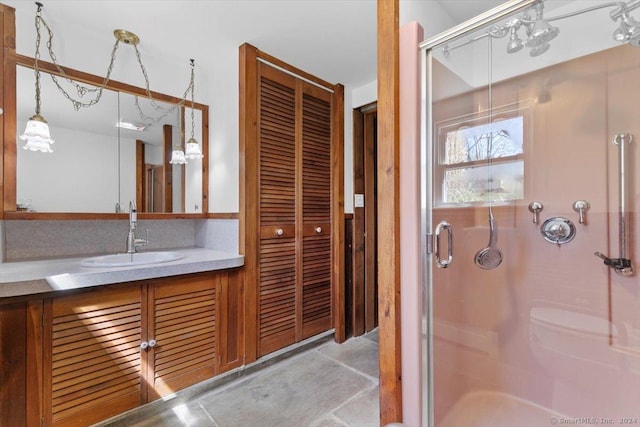 full bathroom with a stall shower, concrete floors, and vanity