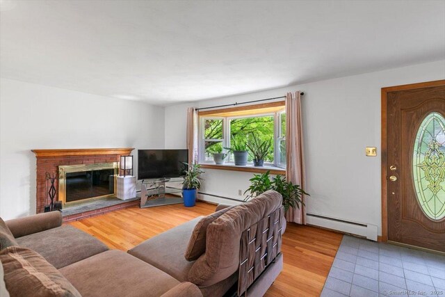 26 Jodi Dr, Wallingford, CT 06492 - living area featuring baseboard heating, a fireplace, and wood finished floors