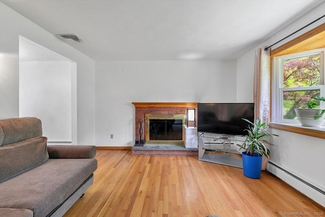 26 Jodi Dr, Wallingford, CT 06492 - living room with a baseboard radiator, wood finished floors, a glass covered fireplace, and baseboards