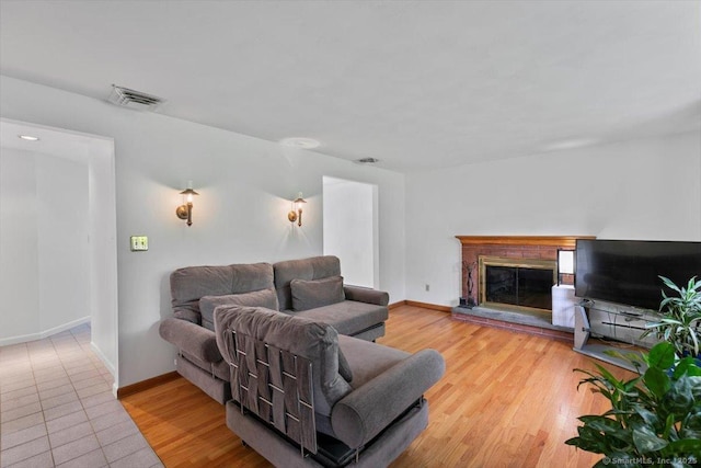26 Jodi Dr, Wallingford, CT 06492 - living area with a glass covered fireplace, baseboards, and wood finished floors