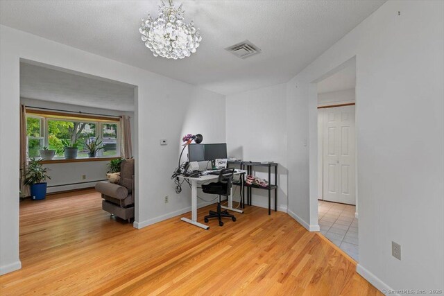 26 Jodi Dr, Wallingford, CT 06492 - office space with a baseboard radiator, light wood-style flooring, a chandelier, and baseboards