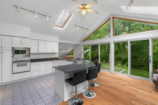 26 Jodi Dr, Wallingford, CT 06492 - kitchen featuring track lighting, oven, a skylight, and high vaulted ceiling