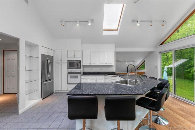 26 Jodi Dr, Wallingford, CT 06492 - kitchen with rail lighting, stainless steel appliances, a sink, healthy amount of natural light, and high vaulted ceiling