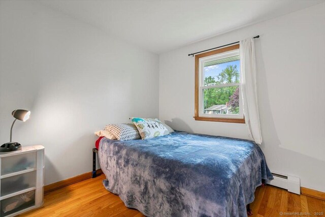 26 Jodi Dr, Wallingford, CT 06492 - bedroom with baseboard heating, wood finished floors, and baseboards