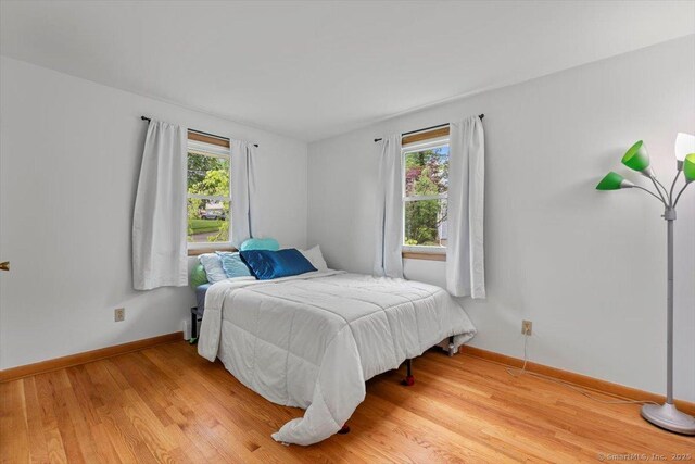 26 Jodi Dr, Wallingford, CT 06492 - bedroom with multiple windows, baseboards, and light wood finished floors