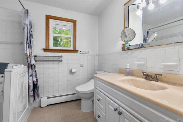 26 Jodi Dr, Wallingford, CT 06492 - full bath featuring a baseboard heating unit, washer / dryer, tile walls, tile patterned floors, and toilet
