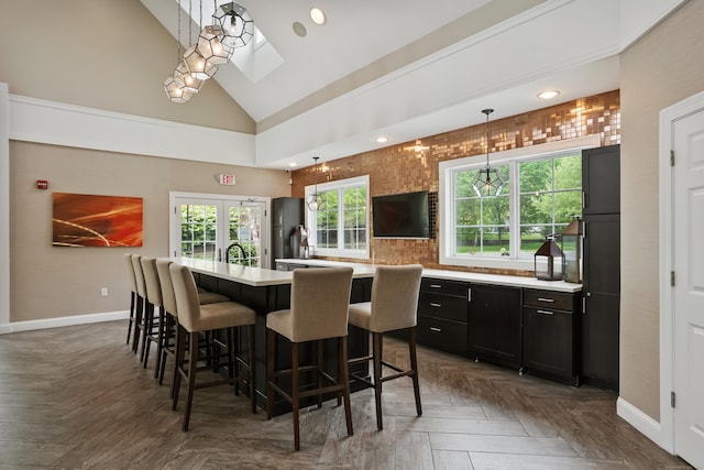 206 Copper Square Dr Unit 206, Bethel, CT 06801 - kitchen featuring baseboards, light countertops, a kitchen bar, a kitchen island with sink, and recessed lighting