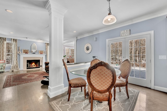 dining area with ornate columns, ornamental molding, baseboards, recessed lighting, and wood finished floors