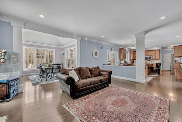 living room with ornate columns, ornamental molding, recessed lighting, wood finished floors, and baseboards
