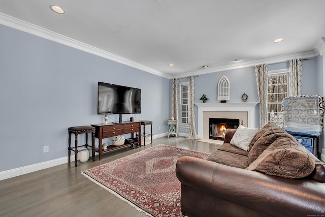 living area featuring baseboards, recessed lighting, a premium fireplace, wood finished floors, and crown molding