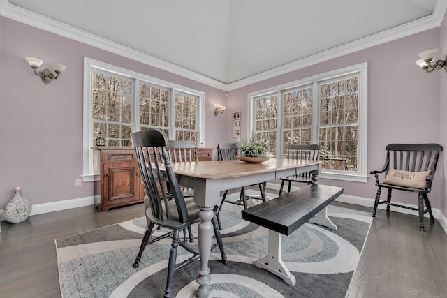 dining space with wood finished floors, baseboards, and crown molding