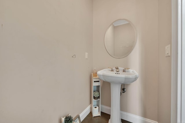 bathroom with baseboards and a sink