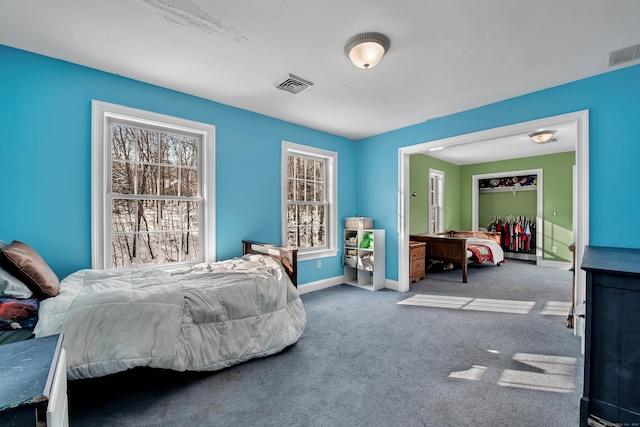 carpeted bedroom featuring baseboards