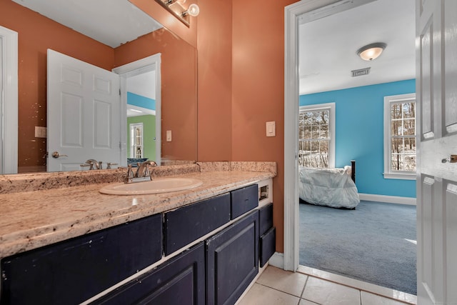 bathroom with tile patterned floors, vanity, and baseboards