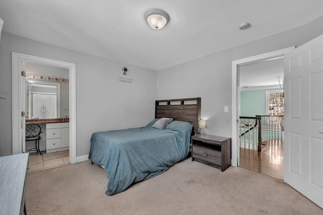bedroom with carpet and connected bathroom