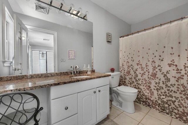 full bath featuring toilet, tile patterned flooring, and vanity