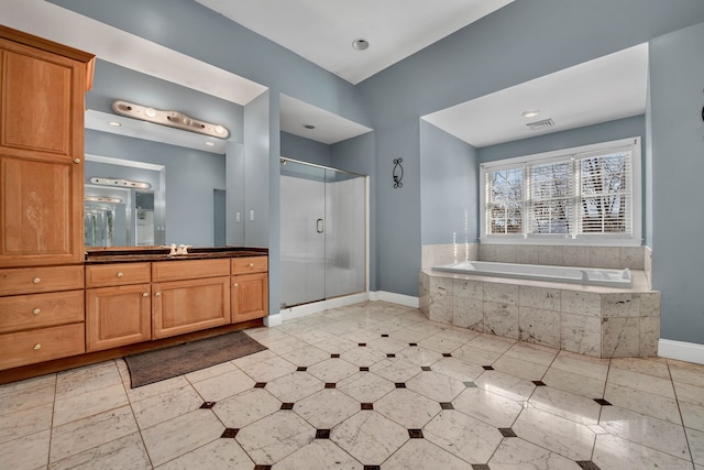 bathroom featuring baseboards, a shower stall, a garden tub, vanity, and tile patterned flooring