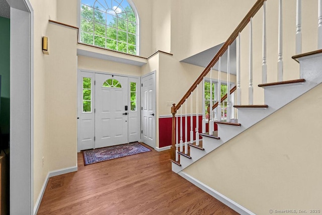 24 Secret Mountain Trl, Canton, CT 06019 - entryway with baseboards, a high ceiling, wood finished floors, and stairway