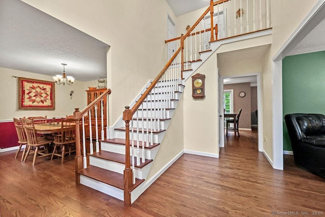 24 Secret Mountain Trl, Canton, CT 06019 - stairway with wood finished floors, a chandelier, baseboards, and a high ceiling