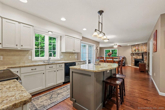 24 Secret Mountain Trl, Canton, CT 06019 - kitchen with dishwasher, a sink, dark wood-type flooring, tasteful backsplash, and a center island