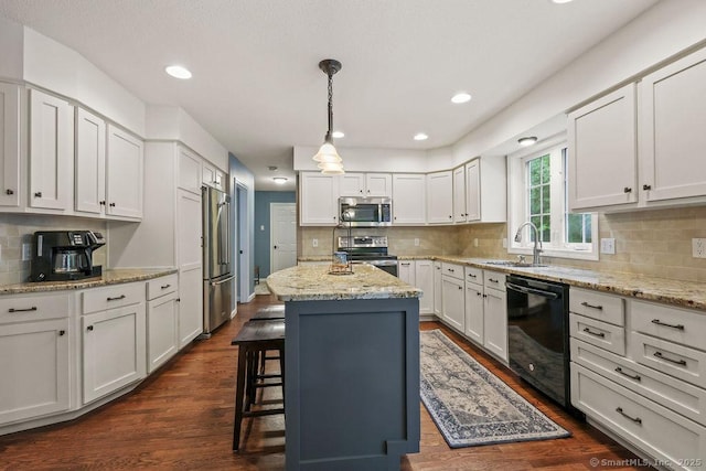 24 Secret Mountain Trl, Canton, CT 06019 - kitchen with stainless steel appliances, a sink, a kitchen bar, a kitchen island, and backsplash