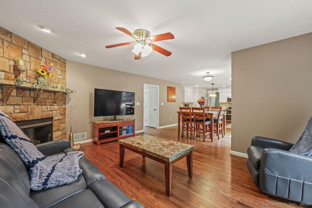 24 Secret Mountain Trl, Canton, CT 06019 - living area with ceiling fan, baseboards, and a stone fireplace