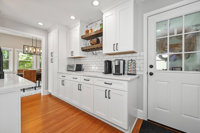 48 Sprucedale Dr, Waterbury, CT 06706 - kitchen with light wood finished floors, a chandelier, open shelves, white cabinets, and recessed lighting