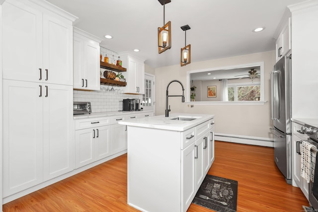 48 Sprucedale Dr, Waterbury, CT 06706 - kitchen featuring baseboard heating, high end refrigerator, a sink, open shelves, and light wood finished floors