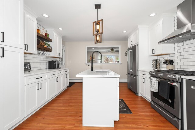 48 Sprucedale Dr, Waterbury, CT 06706 - kitchen featuring wall chimney exhaust hood, high end appliances, a sink, open shelves, and a kitchen island with sink