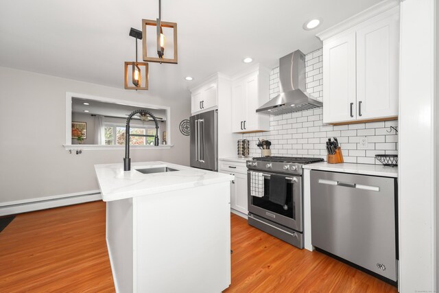 48 Sprucedale Dr, Waterbury, CT 06706 - kitchen featuring appliances with stainless steel finishes, wall chimney exhaust hood, a sink, white cabinetry, and tasteful backsplash