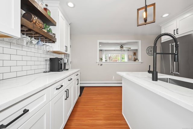 48 Sprucedale Dr, Waterbury, CT 06706 - kitchen featuring a sink, white cabinets, tasteful backsplash, a baseboard radiator, and recessed lighting