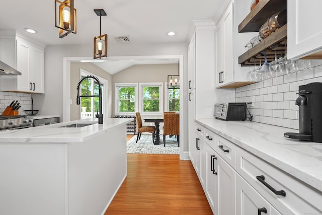 48 Sprucedale Dr, Waterbury, CT 06706 - kitchen featuring a sink, white cabinetry, light wood-type flooring, recessed lighting, and backsplash