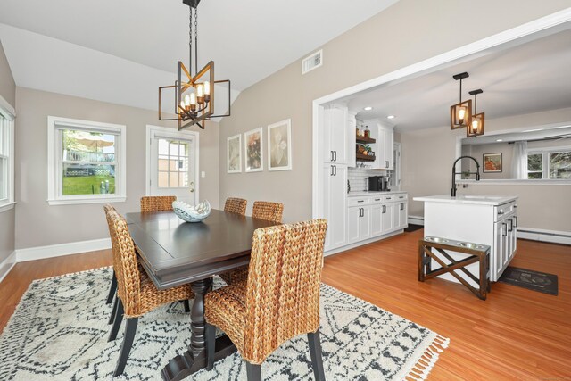 48 Sprucedale Dr, Waterbury, CT 06706 - dining space featuring a chandelier, light wood-style flooring, a baseboard radiator, baseboards, and recessed lighting