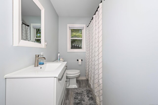 48 Sprucedale Dr, Waterbury, CT 06706 - full bath with wood finished floors, vanity, and toilet