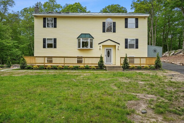 387 New London Tpke, Stonington, CT 06378 - view of front facade featuring a chimney, a front lawn, and a deck