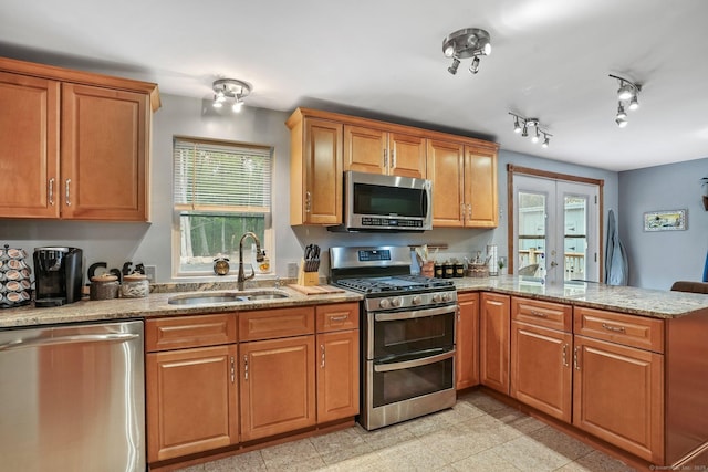 387 New London Tpke, Stonington, CT 06378 - kitchen with appliances with stainless steel finishes, a sink, a peninsula, and light stone countertops