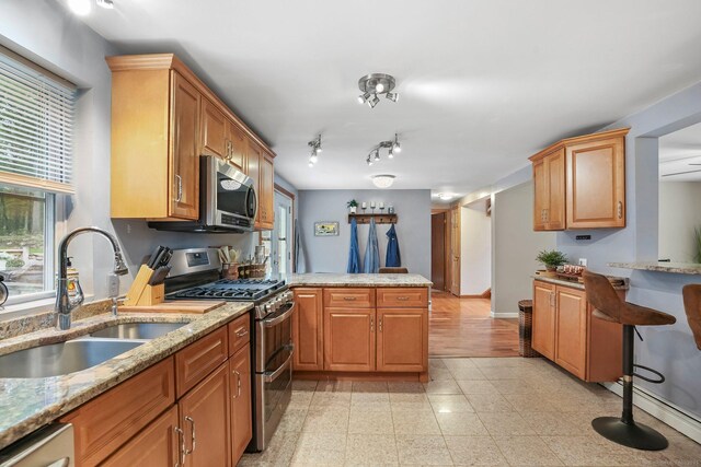 387 New London Tpke, Stonington, CT 06378 - kitchen with stainless steel appliances, a sink, a peninsula, and healthy amount of natural light