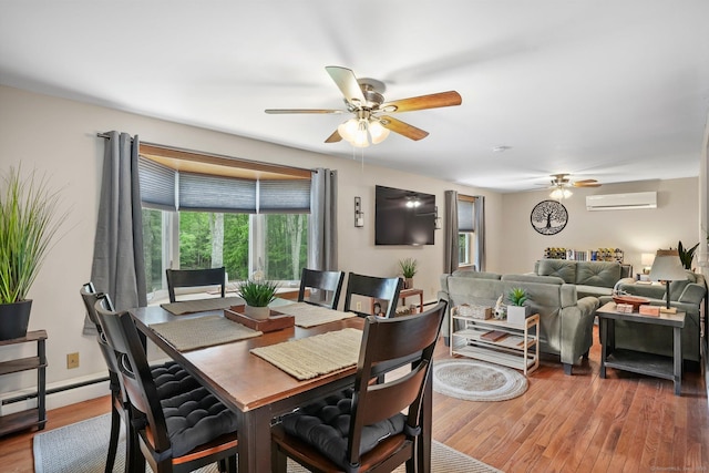 387 New London Tpke, Stonington, CT 06378 - dining area featuring an AC wall unit, ceiling fan, healthy amount of natural light, and wood finished floors