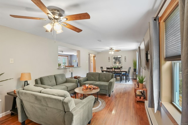 387 New London Tpke, Stonington, CT 06378 - living room with ceiling fan, light wood-style floors, baseboard heating, and baseboards