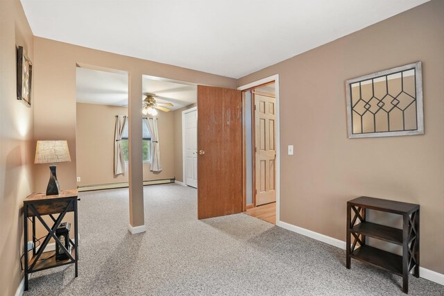 387 New London Tpke, Stonington, CT 06378 - corridor with carpet floors, baseboards, and a baseboard radiator