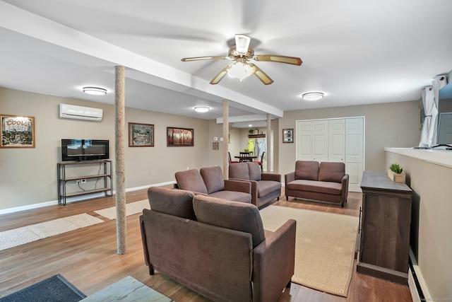 387 New London Tpke, Stonington, CT 06378 - living area with a wall mounted air conditioner, wood finished floors, baseboards, and baseboard heating