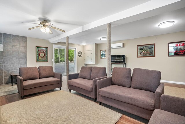 387 New London Tpke, Stonington, CT 06378 - living area featuring an AC wall unit, wood finished floors, ceiling fan, and baseboards