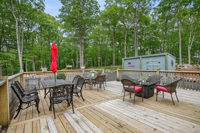 387 New London Tpke, Stonington, CT 06378 - deck featuring outdoor dining area and view of scattered trees