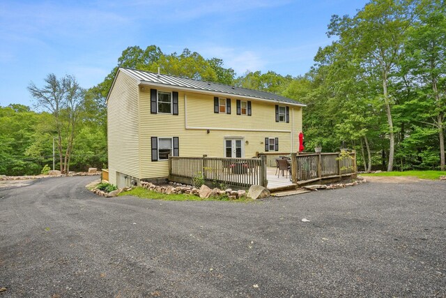 387 New London Tpke, Stonington, CT 06378 - view of front of house with a deck, metal roof, and a standing seam roof