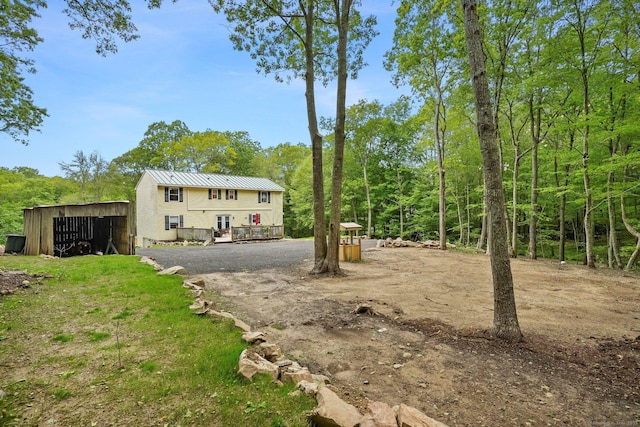 387 New London Tpke, Stonington, CT 06378 - view of yard featuring a wooden deck, a pole building, and an outdoor structure