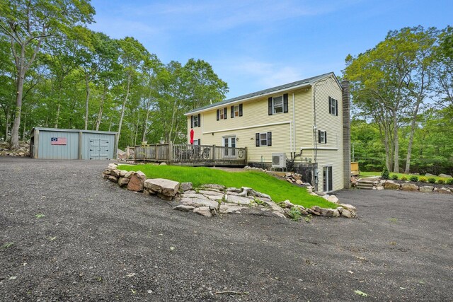 387 New London Tpke, Stonington, CT 06378 - rear view of house featuring a wooden deck and an outbuilding